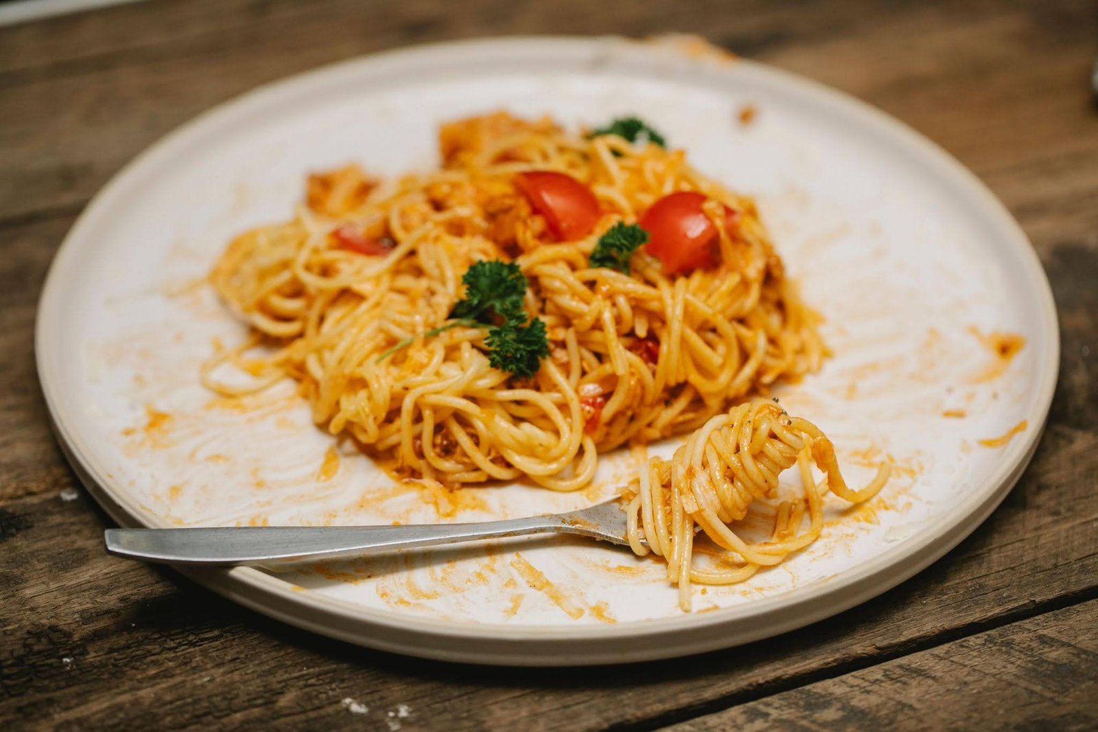A plate of spaghetti left half-eaten